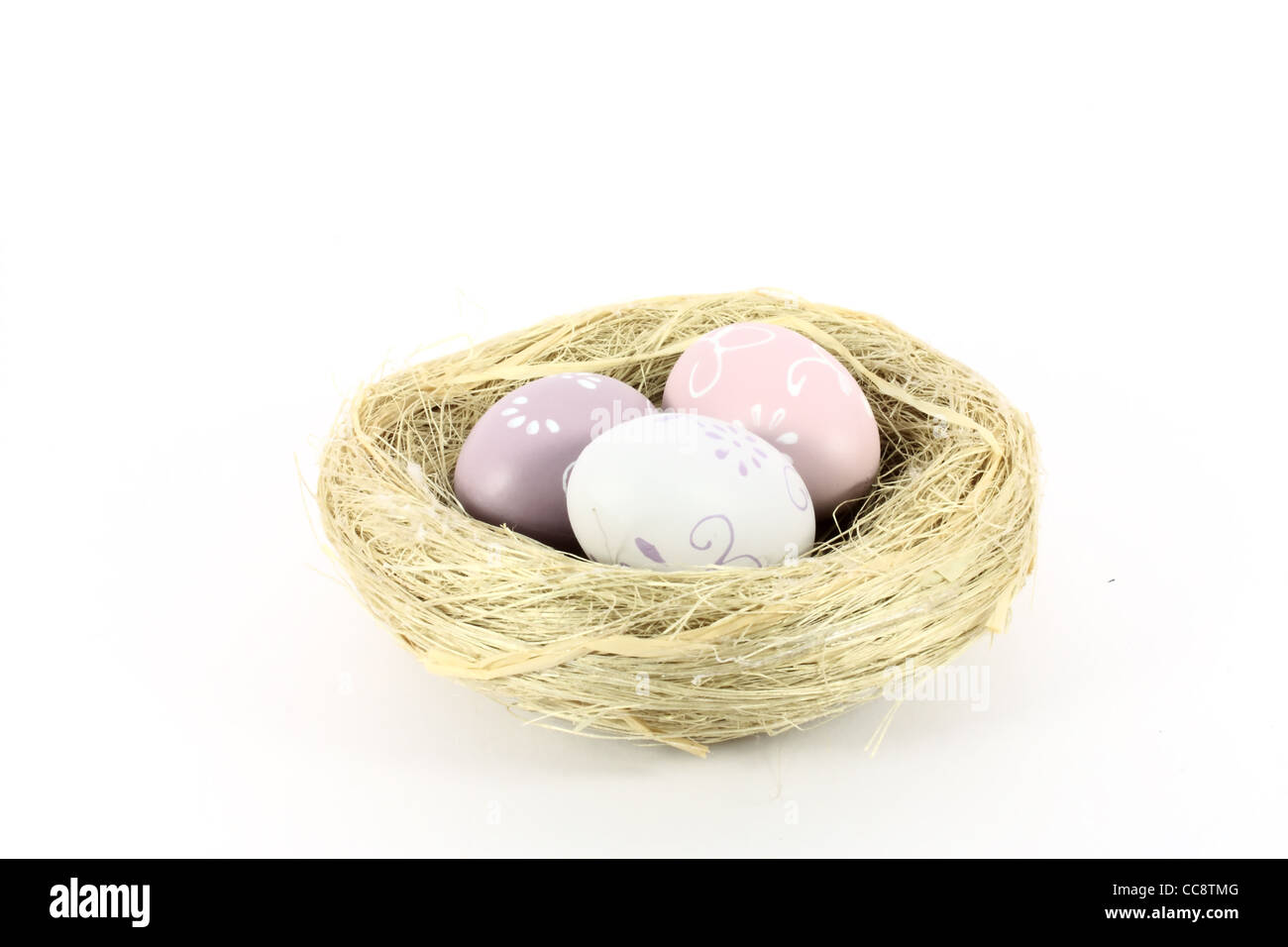 A bird nest with colored eggs isolated on white Stock Photo - Alamy