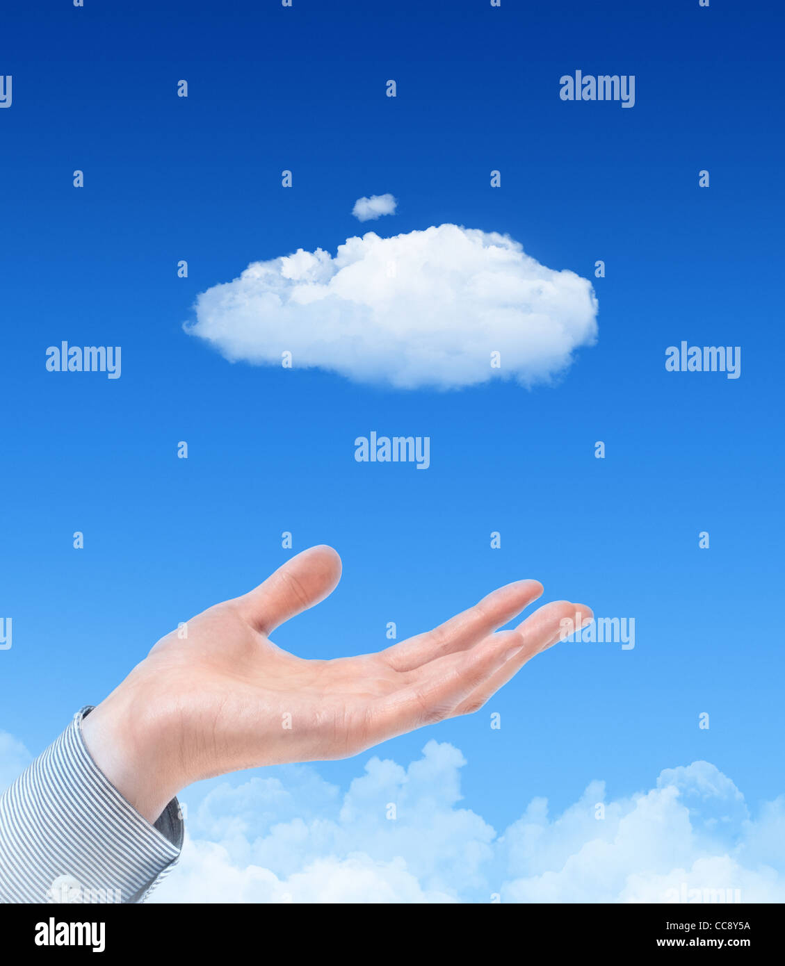 Man hand propose cloud against blue sky with clouds on background. Concept image on cloud computing and eco theme. Stock Photo