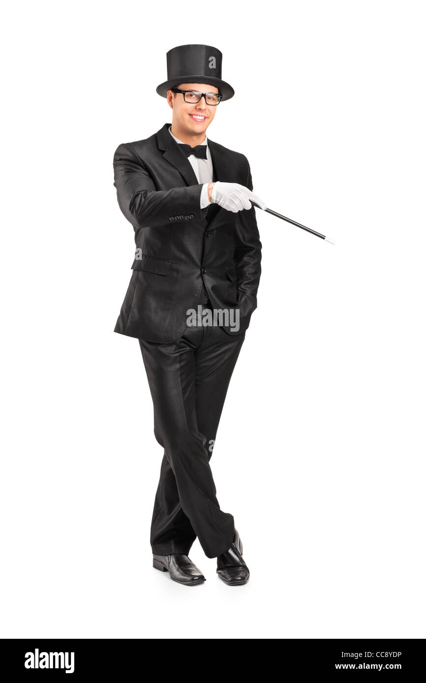 Full length portrait of a magician holding a magic wand posing Stock Photo