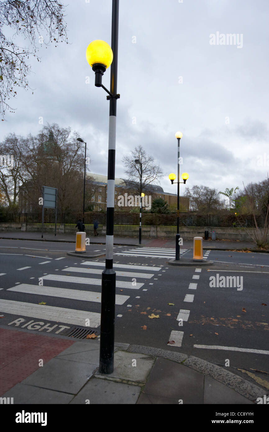 illuminated belisha beacon on a road pedestrian crossing on cold wintry day in London England UK United kingdom Stock Photo