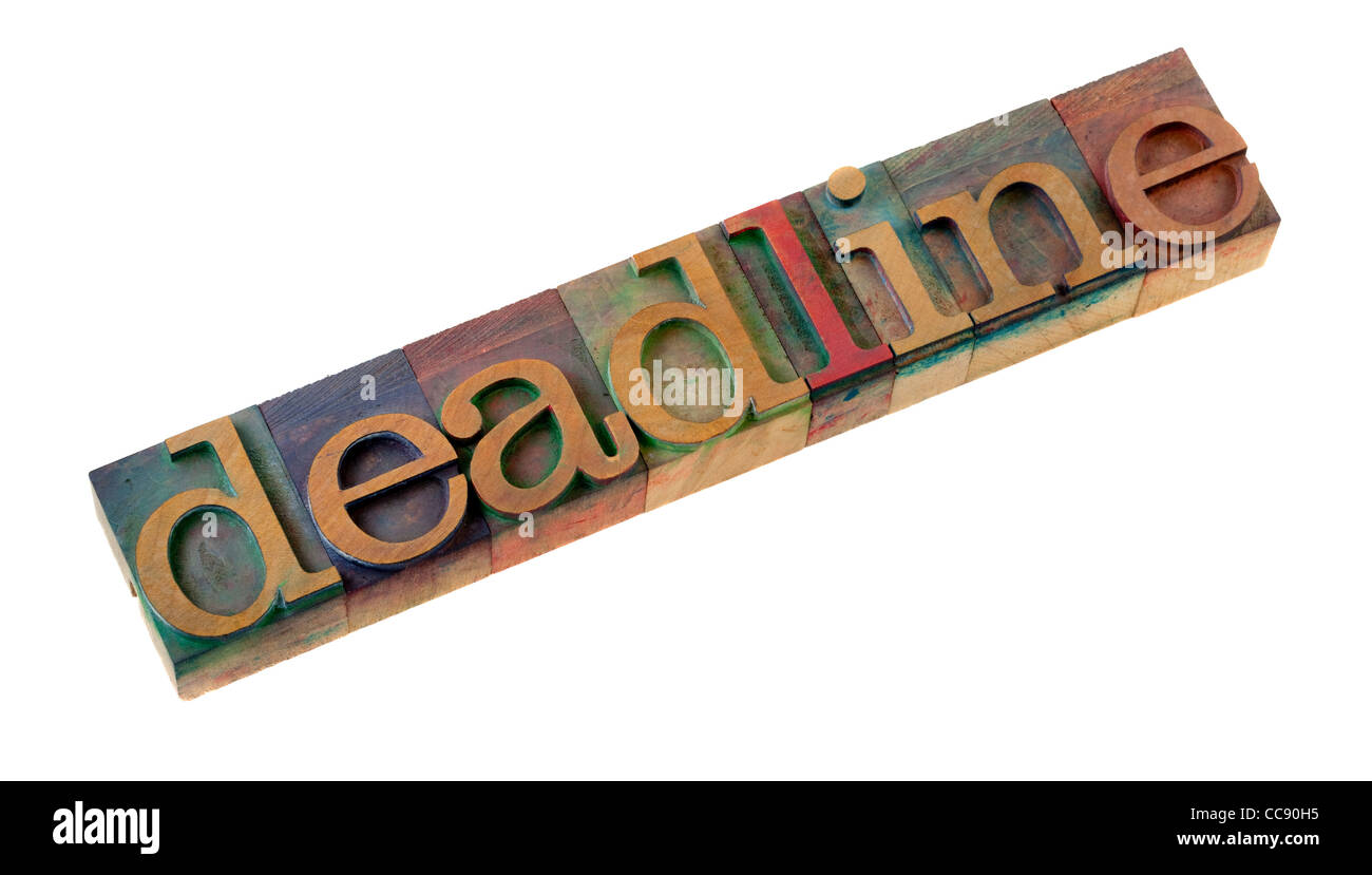 the deadline word in vintage wooden letterpress type blocks, stained by color ink, isolated on white Stock Photo