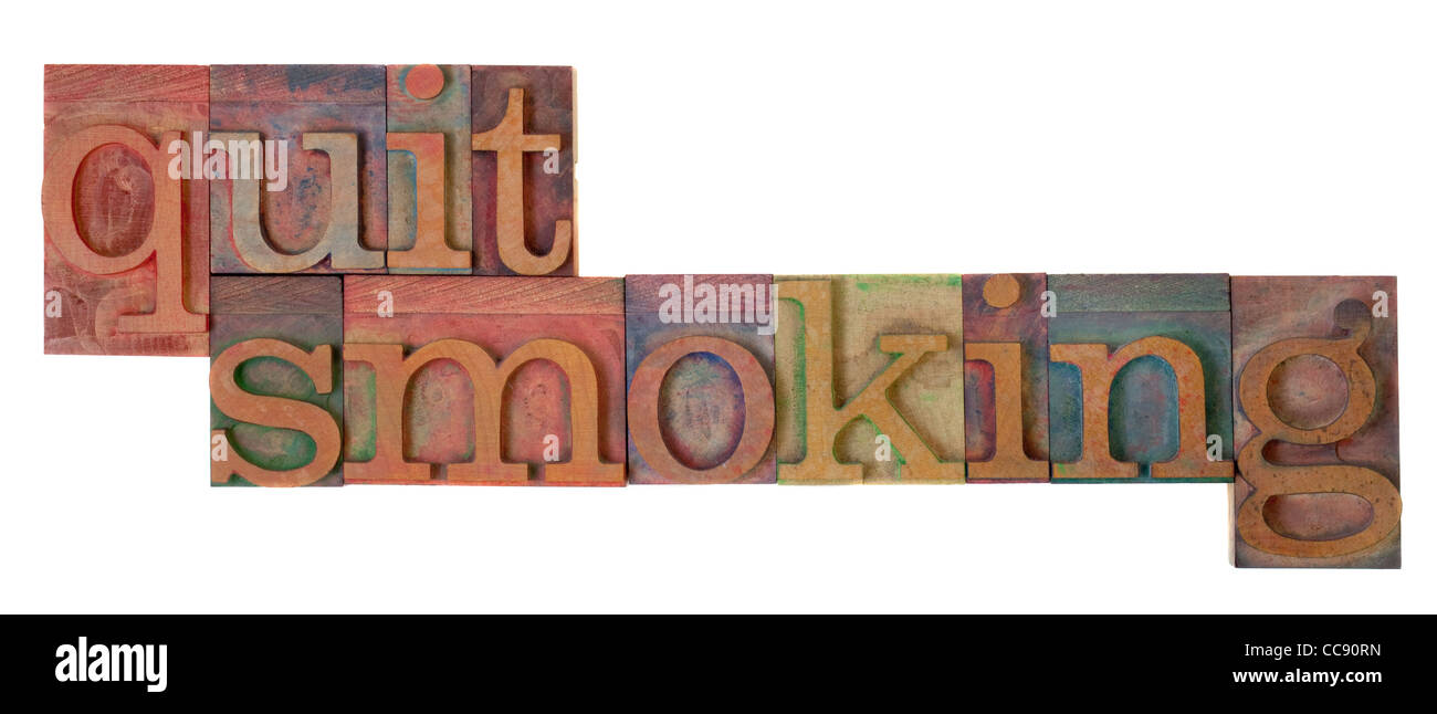 quit smoking words in vintage wooden letterpress type blocks, stained by color ink, isolated on white Stock Photo