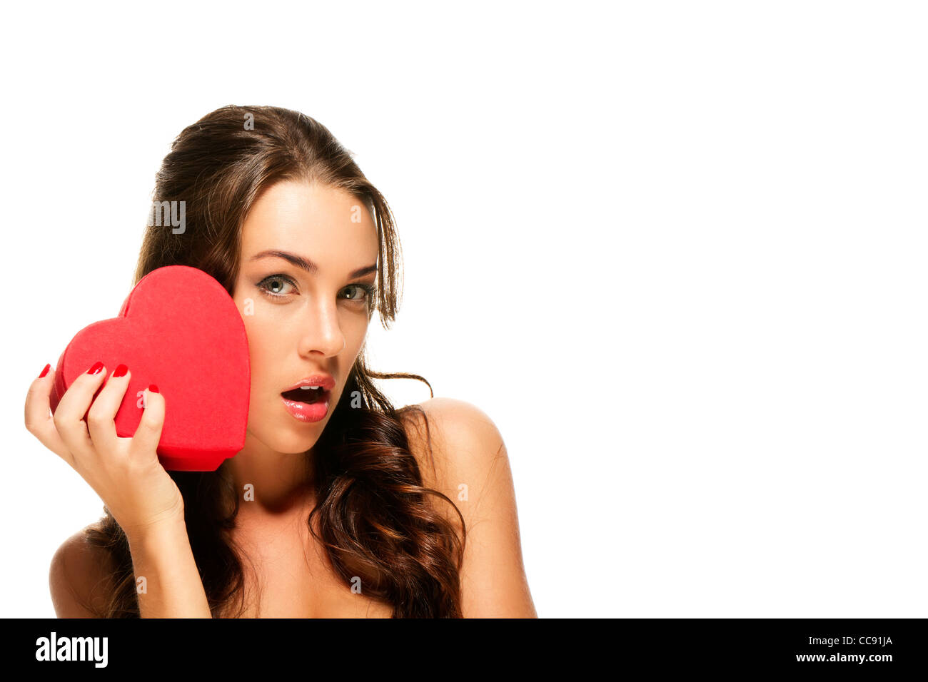 beautiful surprised woman with a red heart on white background Stock ...