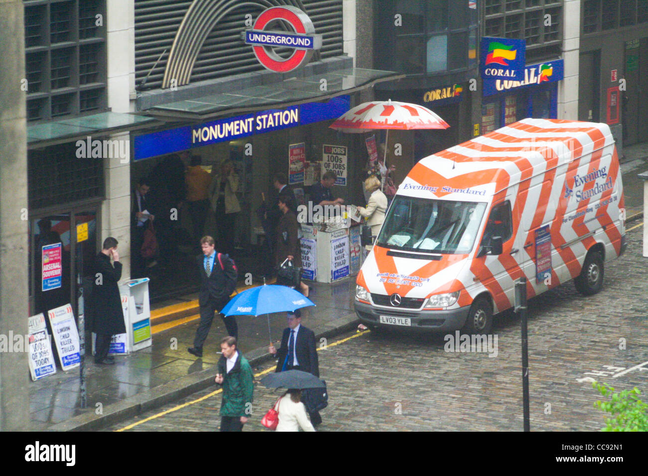 Entrance to Monument Station, London Underground, January 2006. Shot of commuters and the 'Evening Standard' newspaper van Stock Photo