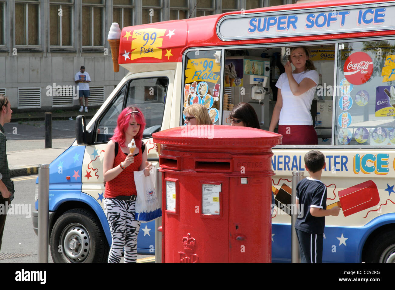 Ice cream van parked by Red London letter box. Children buying ice