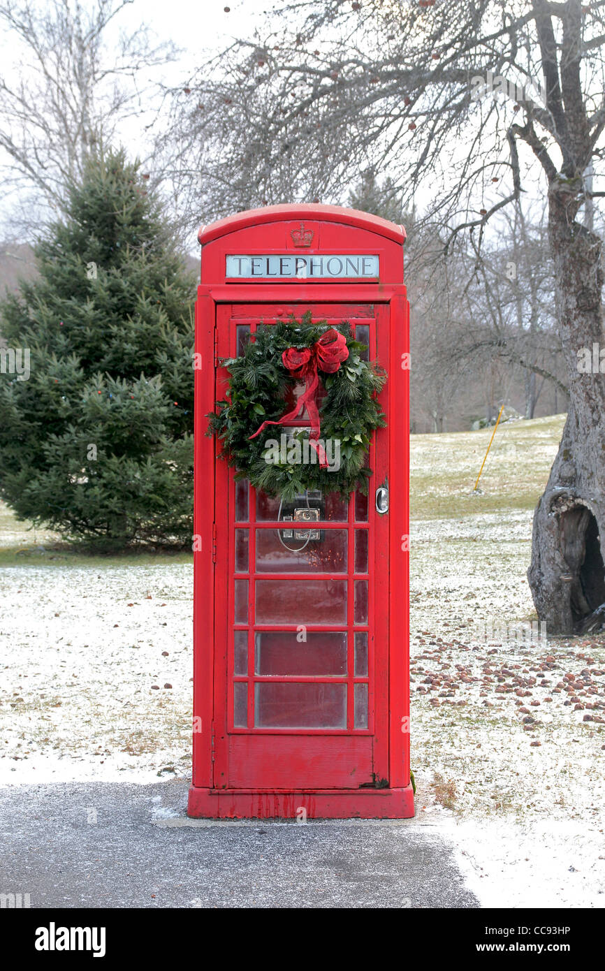 An old-fashioned British telephone booth decorated with a Christmas wreath, in the small town of Rowe, Massachusetts, USA Stock Photo