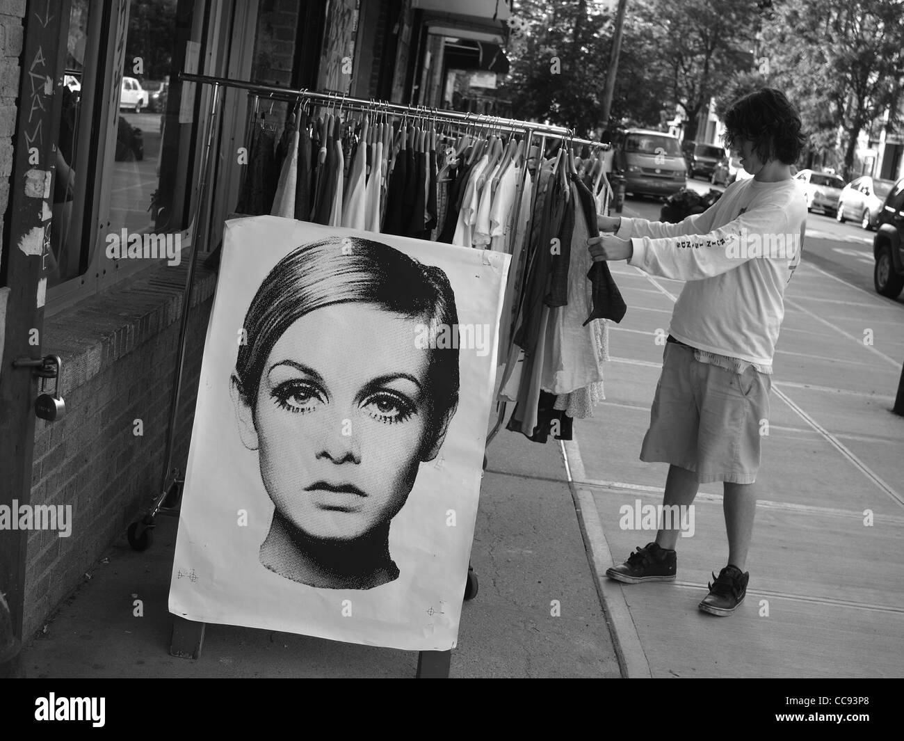 Shopping for clothes in Williamsburg, Brooklyn, near a poster of 60s British supermodel Twiggy Stock Photo