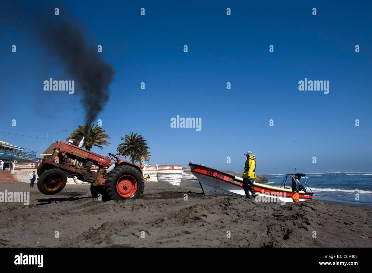 A tractor pulling a boat on shore, Pichilemu beach Chile Stock Photo