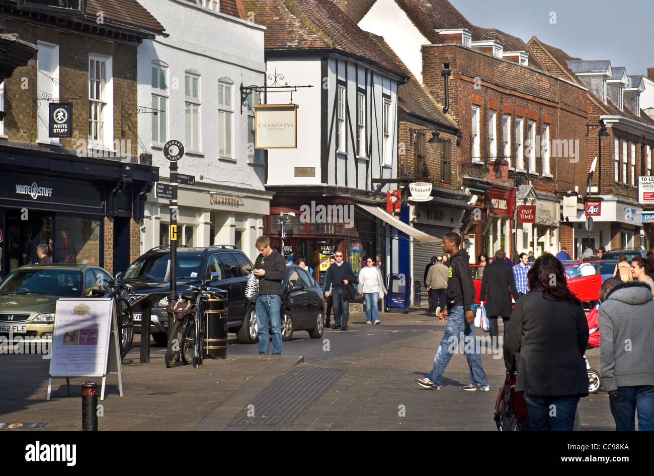 Shops and people in Market Place/ High street, St Albans, Hertfordshire, England, UK Stock Photo