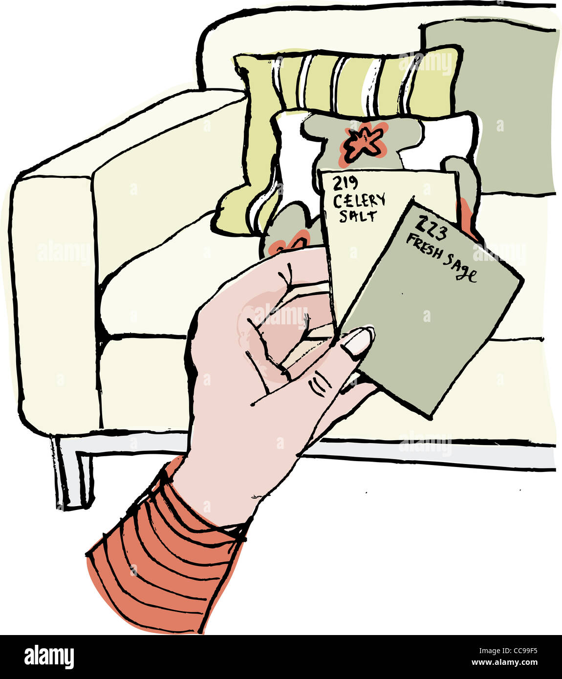 A hand holding paint chips to compare colors to the sofa Stock Photo