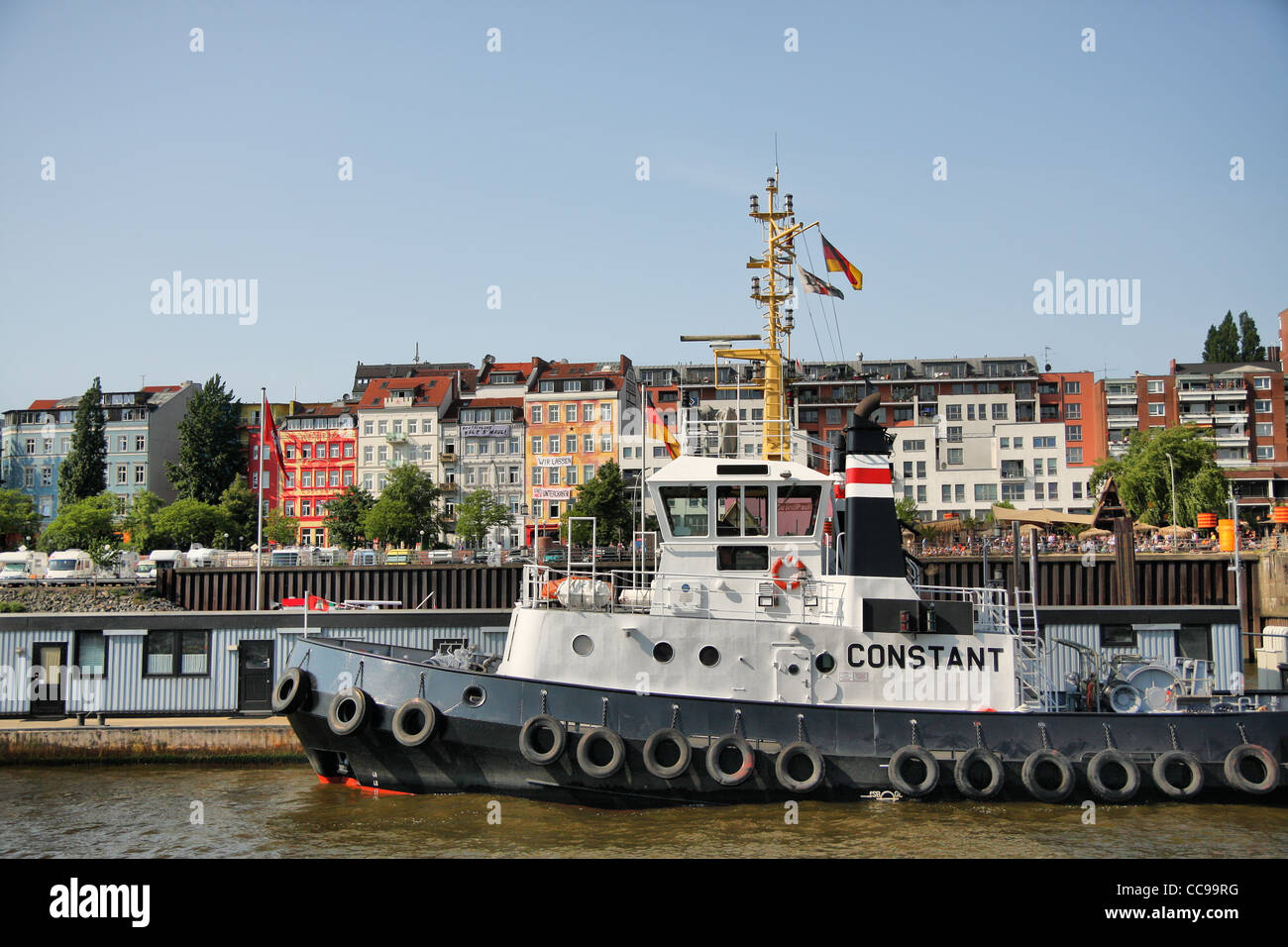 Tugboat infront of the Hafenstrasse and the Strandpauli-Bar in Hamburg, Germany. Stock Photo