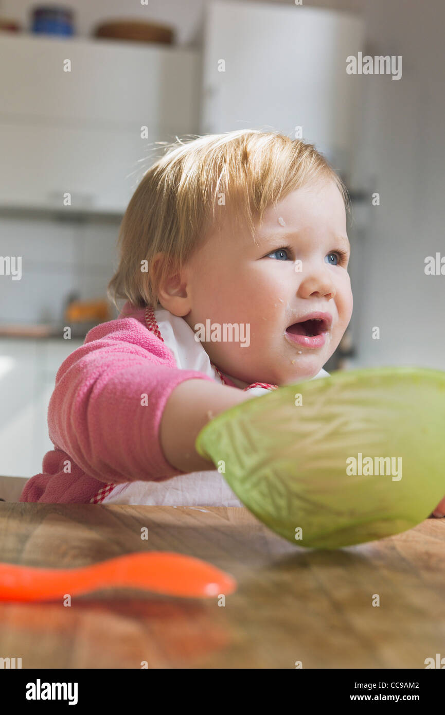 Baby girl Eating from Bowl Stock Photo
