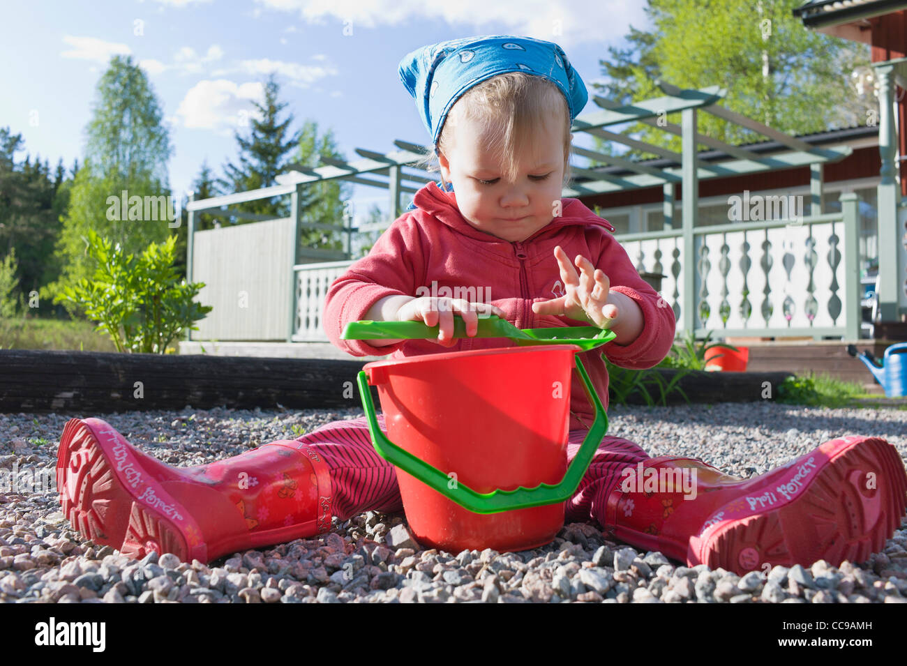 Girl Playing with Shovel and Pail Stock Photo