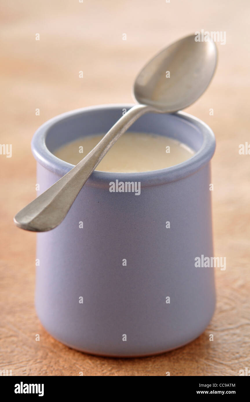 Close-up of Spoon Balanced on Mug of Yogurt Stock Photo - Alamy