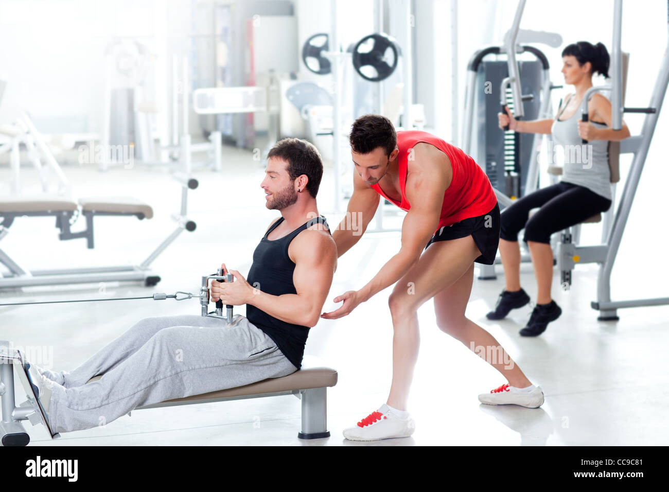 man in gym with personal trainer and fitness woman Stock Photo - Alamy