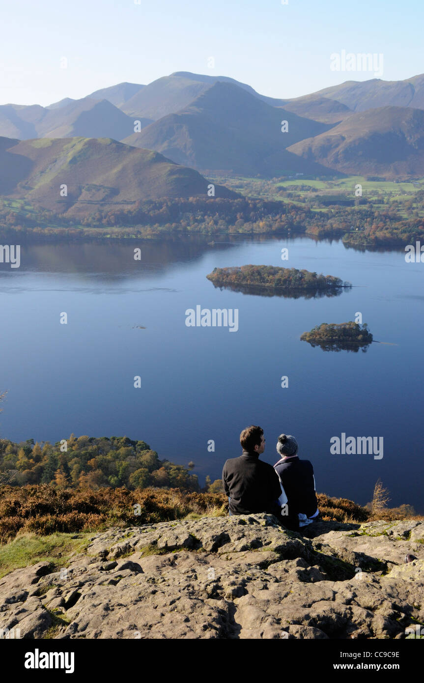 Couple looking over Derwent Water from Falcon Crag, Lake District Stock Photo