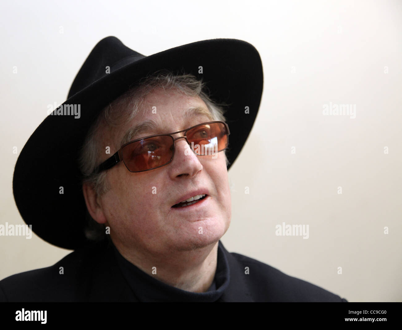 smiling senior citizen in black hat and sunglasses Stock Photo