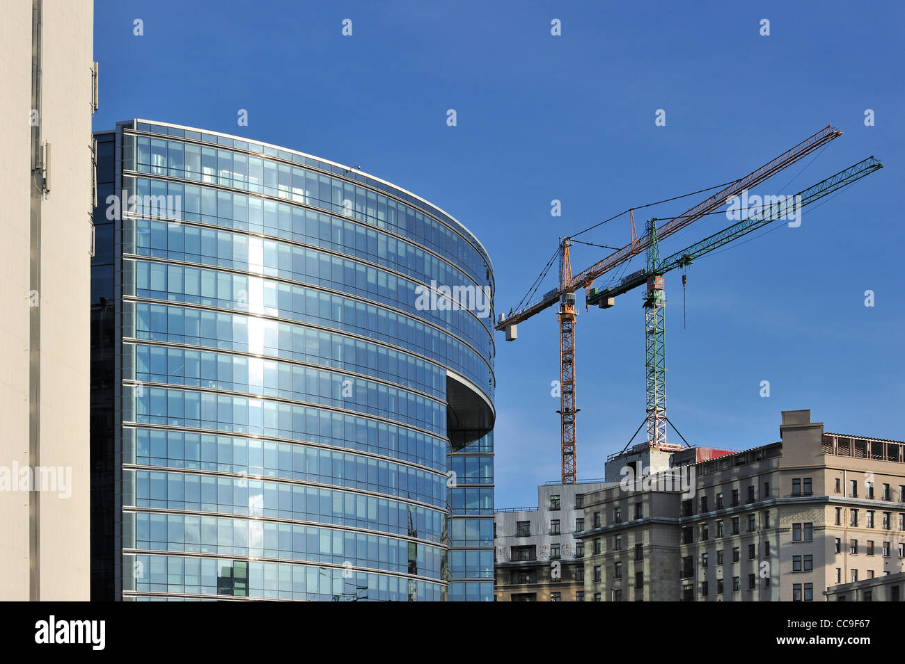 Building cranes and the Lex building, housing government offices of the Council of the European Union in Brussels, Belgium Stock Photo