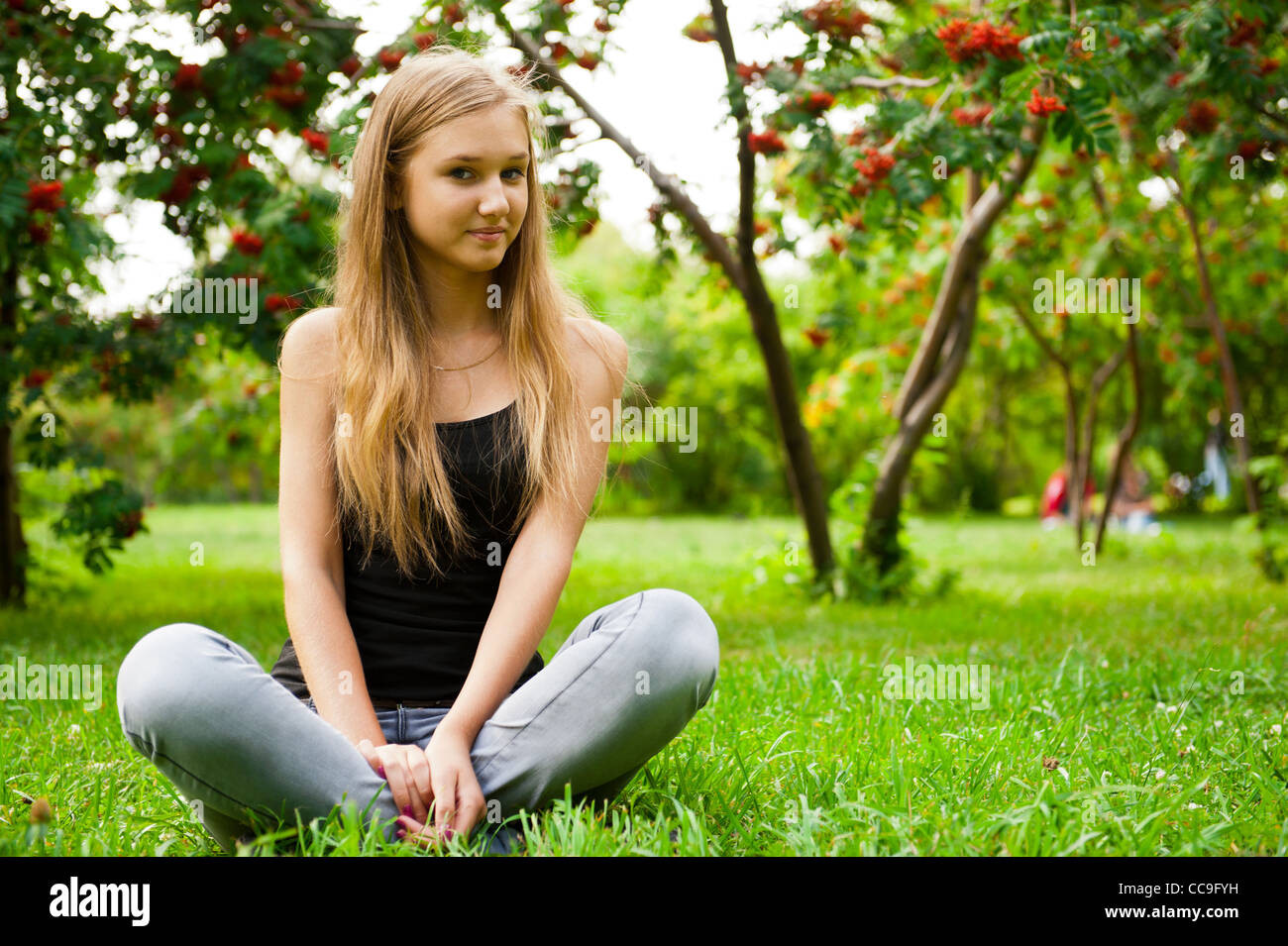 Тема молодая. Девушка сидящая на траве в лесу или парке. Teen redhead Marina pisses Outdoor sitting on the Summer.