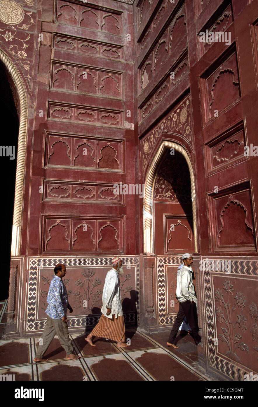 Muslim men walk to pray inside a sandstone structure next to the Taj Mahal in Agra, India. Built in 1653 by Emperor Shah Jahan. Stock Photo