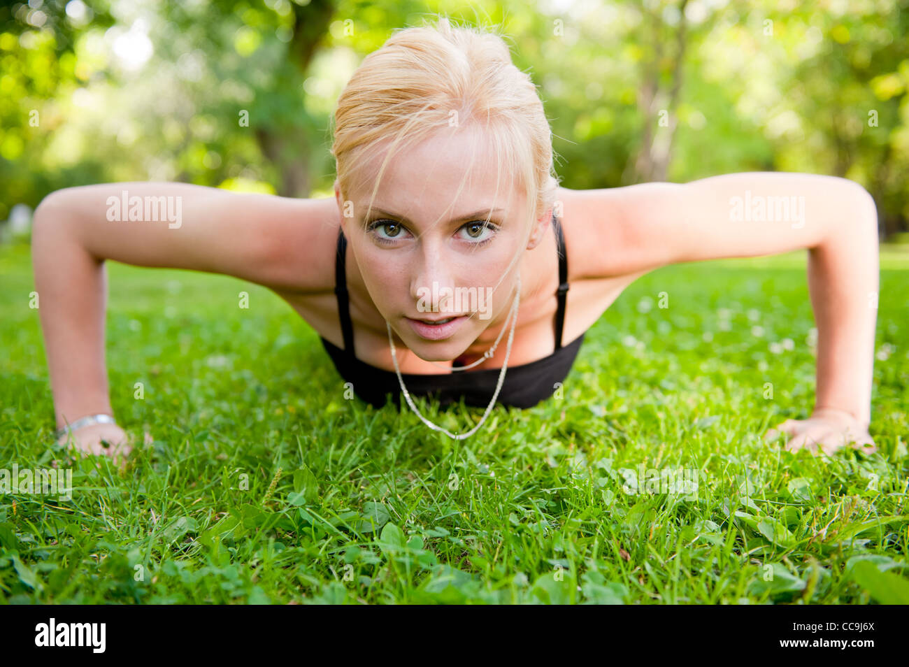 Woman doing push up on grass hi-res stock photography and images - Alamy