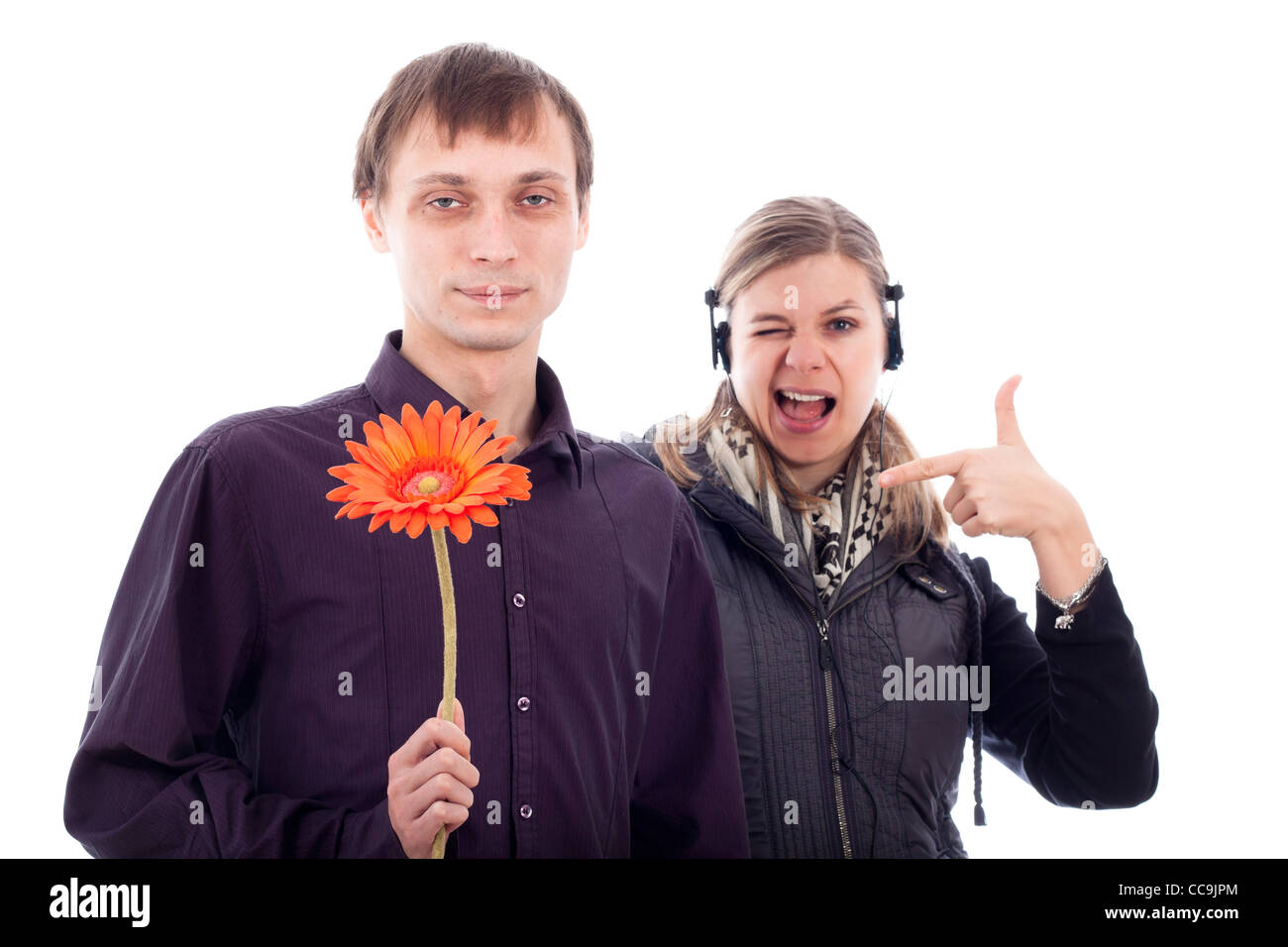 Funny geek man holding flower and rebel woman pointing at him, isolated on white background. Stock Photo