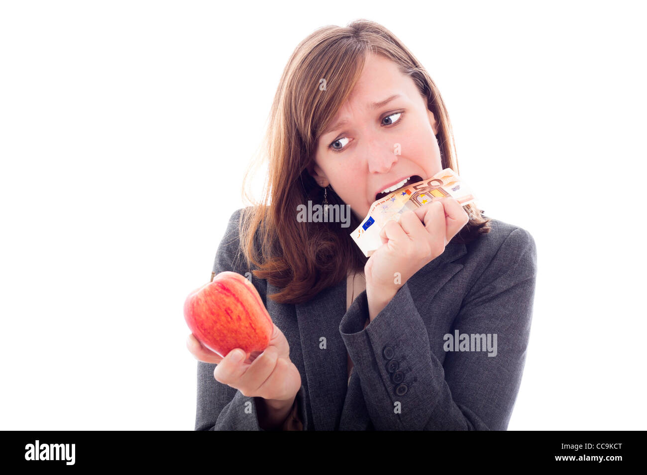 European crisis concept. Desperate woman with apple, eating Euro bank note, isolated on white background. Stock Photo