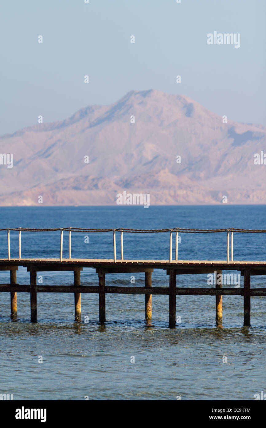 Bridge on the beach at the hotel in Sharm El Sheikh, Egypt. In the background: Red Sea and Tiran Island. Stock Photo