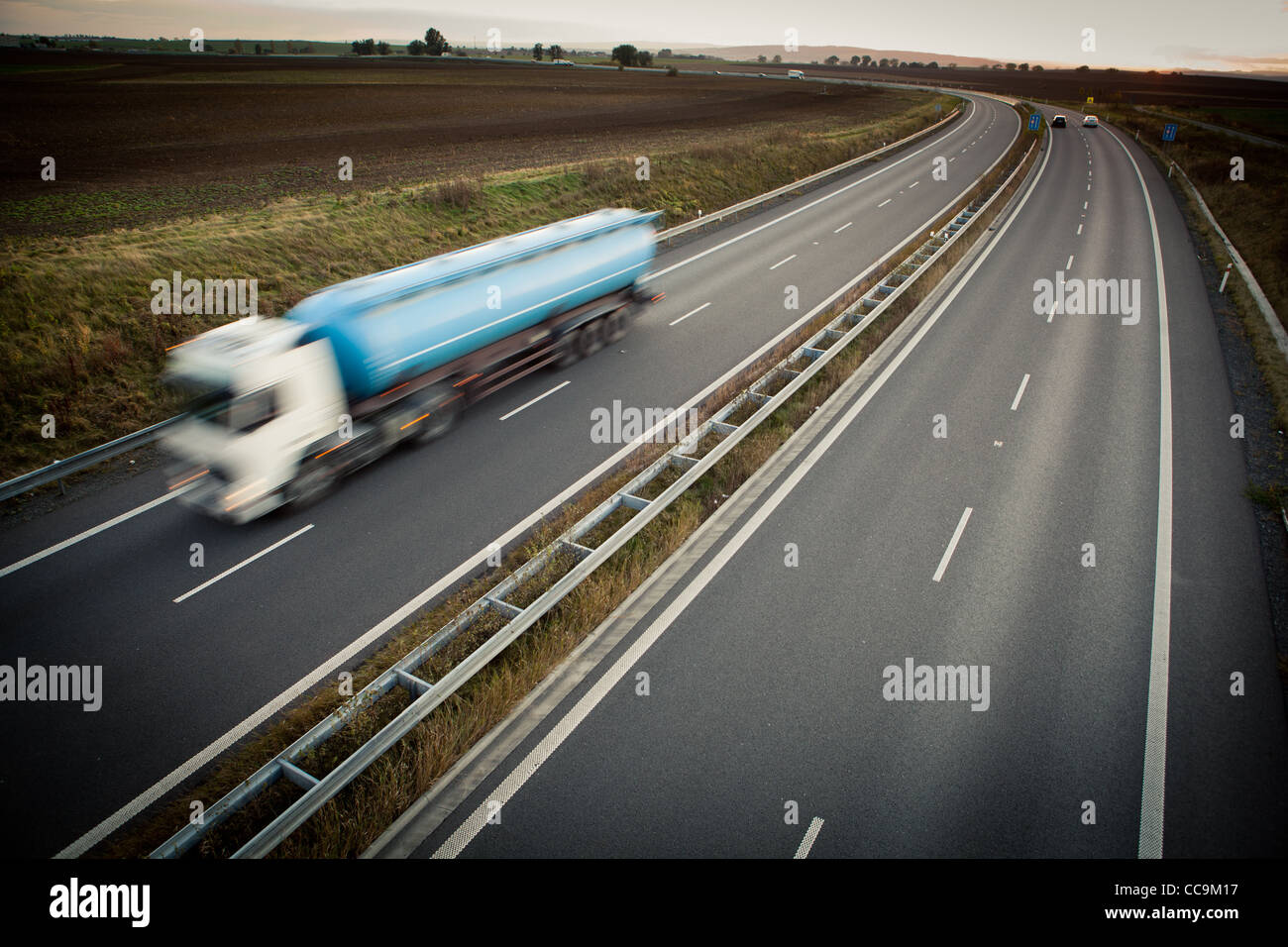 highway traffic - motion blurred truck on a highway/motorway/speedway ...