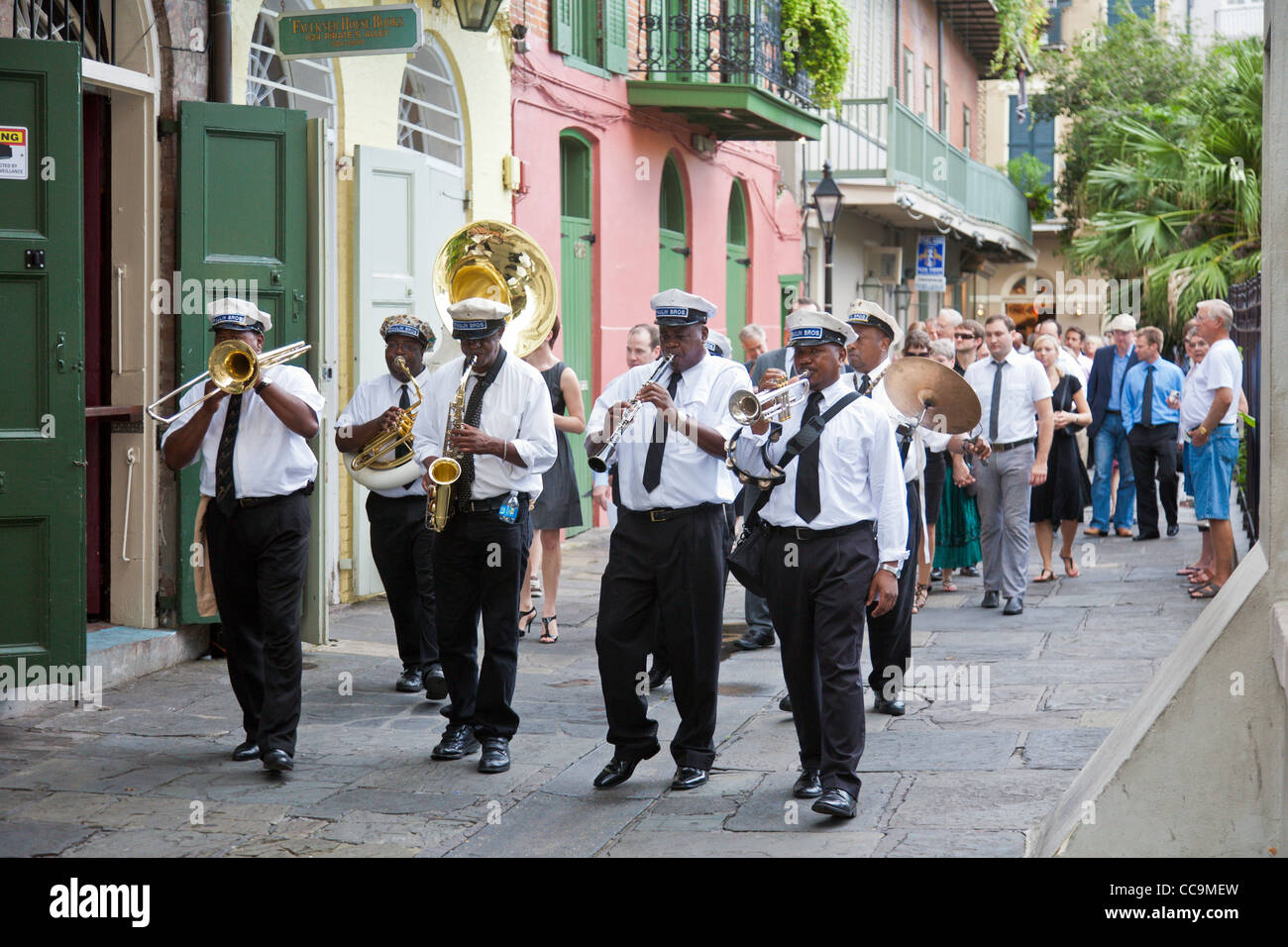 Paulin Brothers Brass Band playing music and leading a funeral procession in the French Quarter of New Orleans, LA Stock Photo