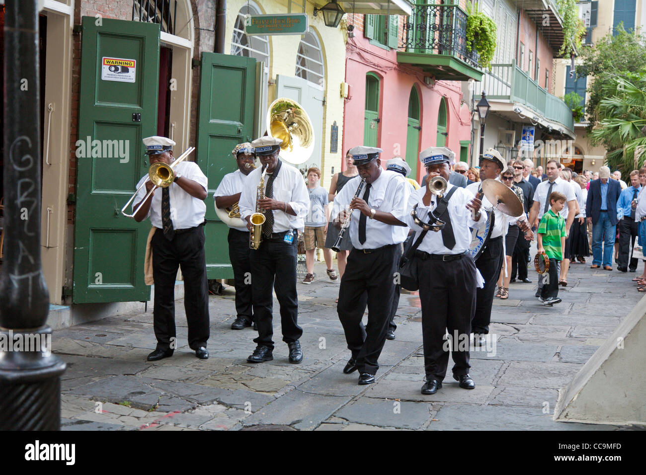 Paulin Brothers Brass Band playing music and leading a funeral procession in the French Quarter of New Orleans, LA Stock Photo