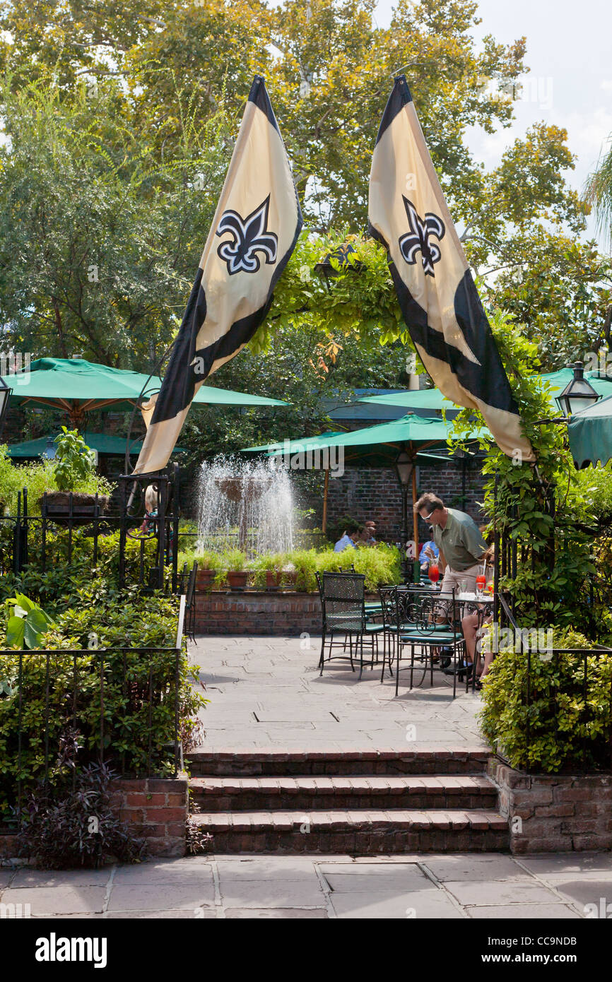 New Orleans Saints flags decorate Courtyard Restaurant entrance at Pat O'Brien's in the French Quarter Stock Photo