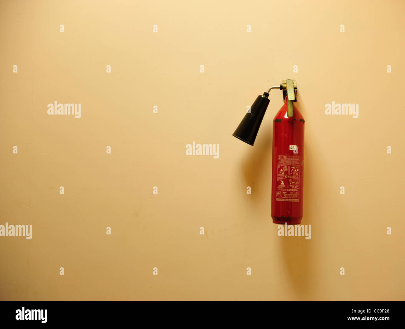 Fire extinguisher on the yellow wall Stock Photo Alamy