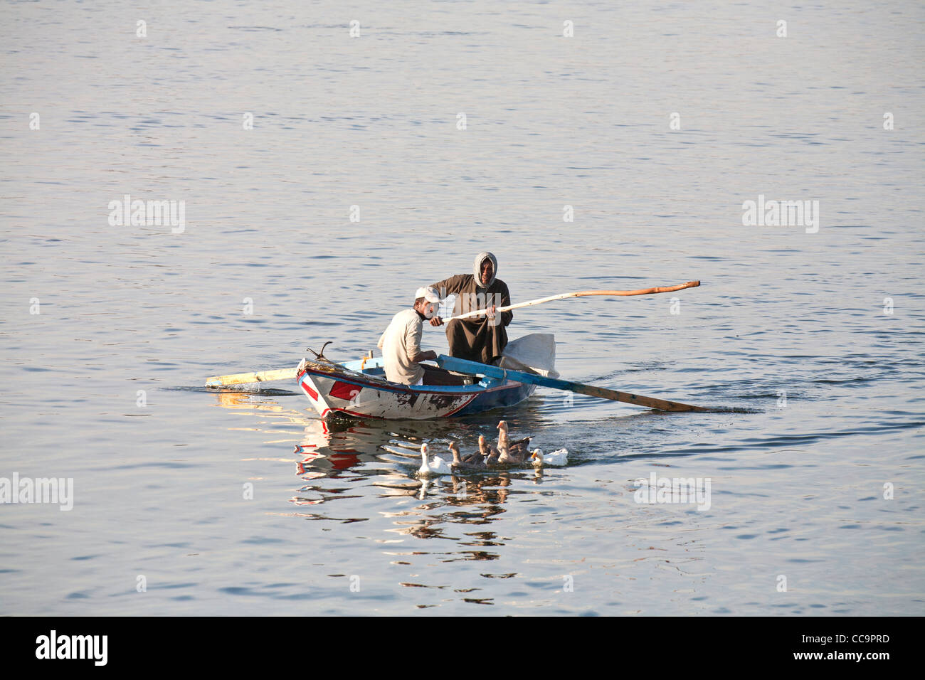 Fishing with small boat using nets on the river Nile Egypt Stock Photo