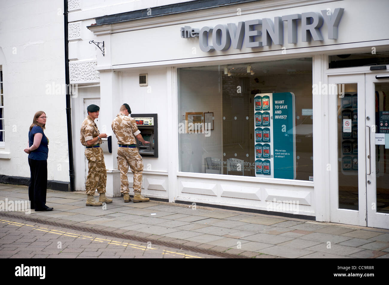 Soldiers queue at a cashpoint machine Stock Photo Alamy