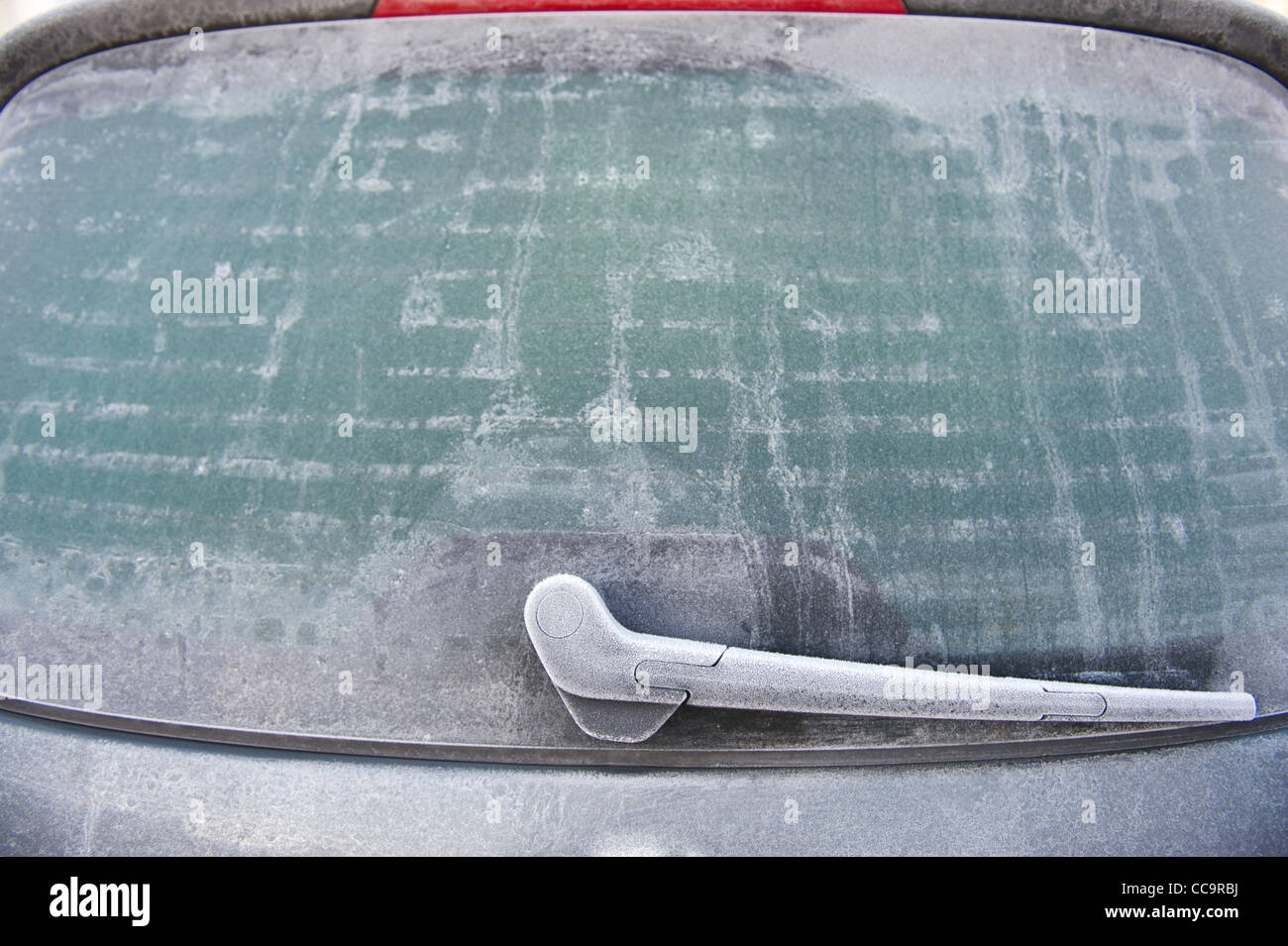 Car rear window covered in ice on a frosty winter morning Stock Photo