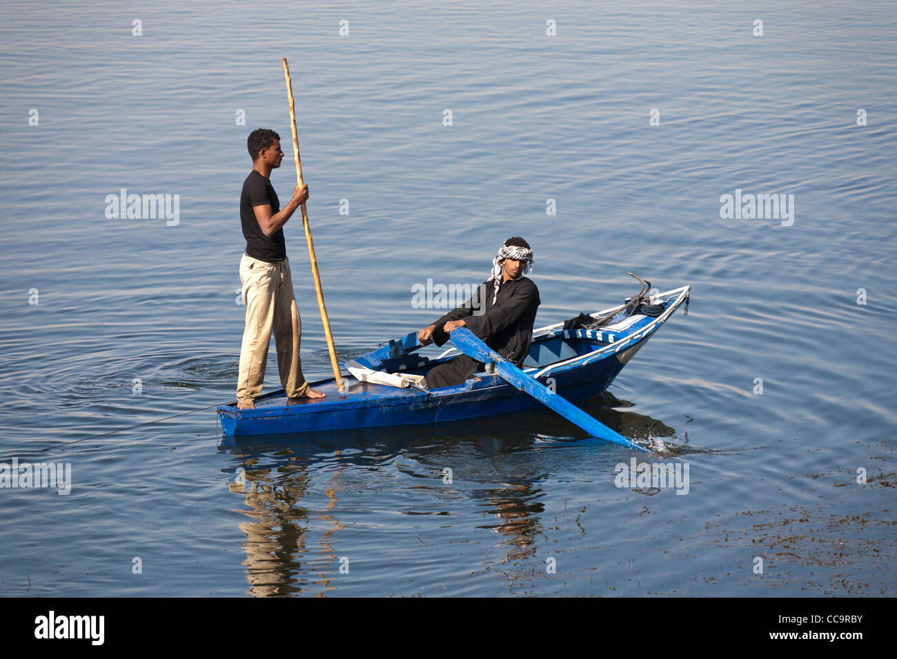 Fishing with small boat using nets and poles on the river Nile Egypt Stock Photo Alamy