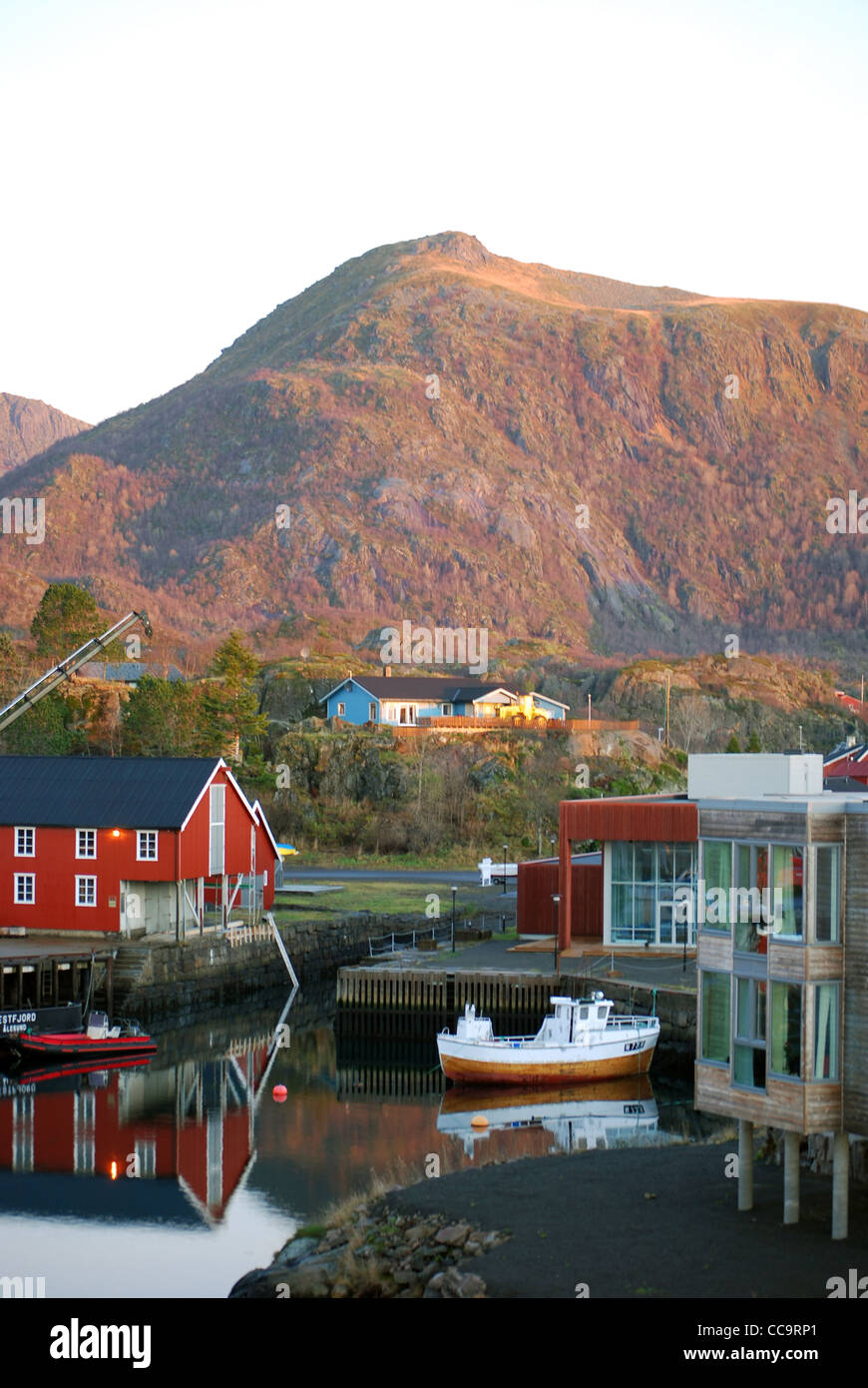 small port with ship and houses in front of huge mountain in Kabelvåg, Lofoten, Norway Stock Photo