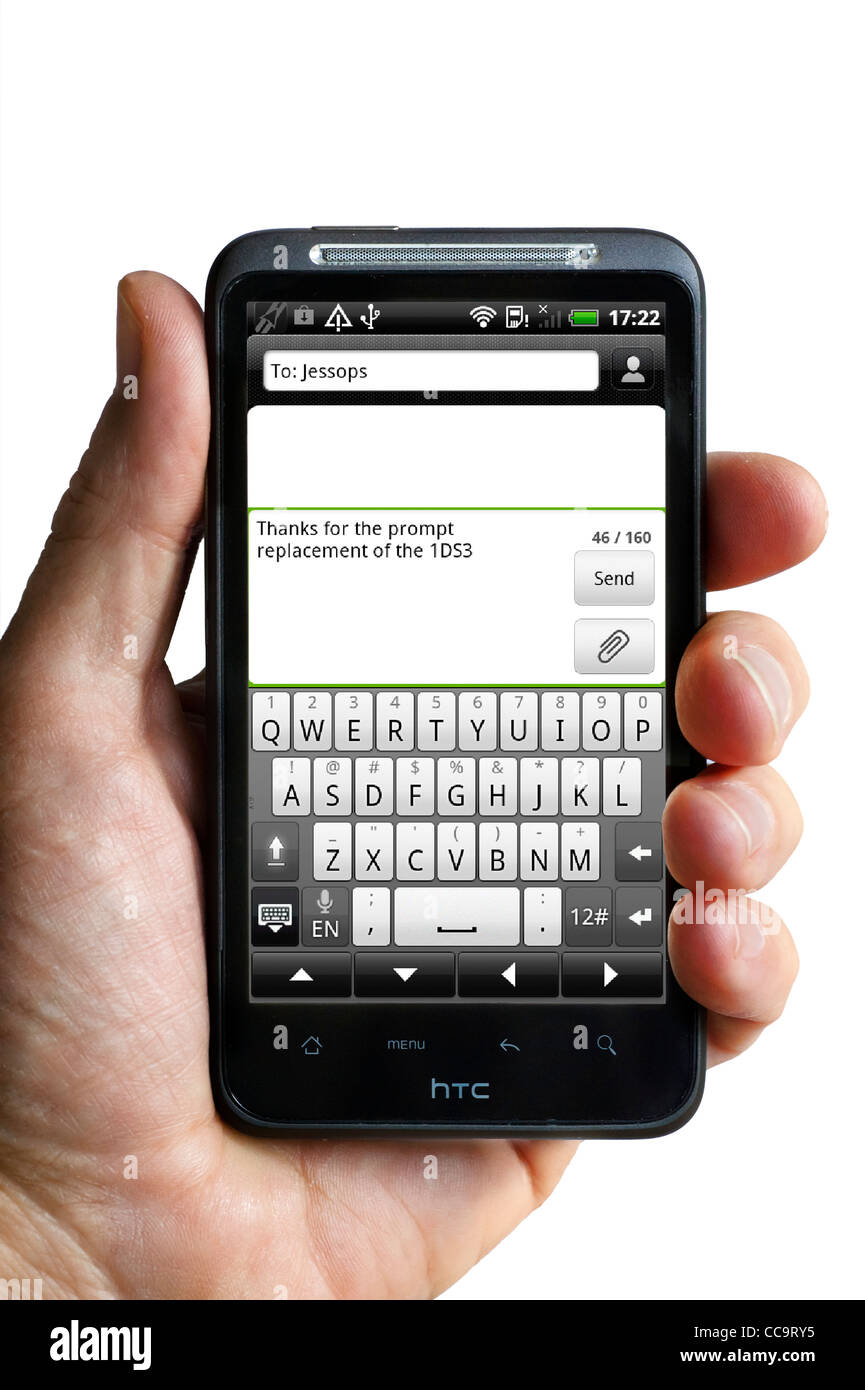Sending a text message on an android HTC smartphone Stock Photo