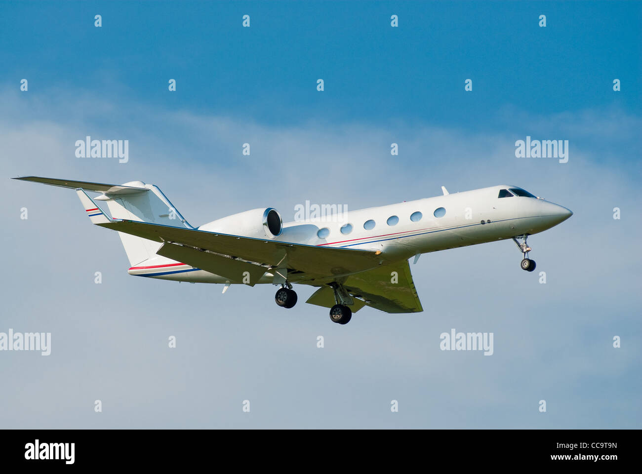 small private jet landing with gears down Stock Photo
