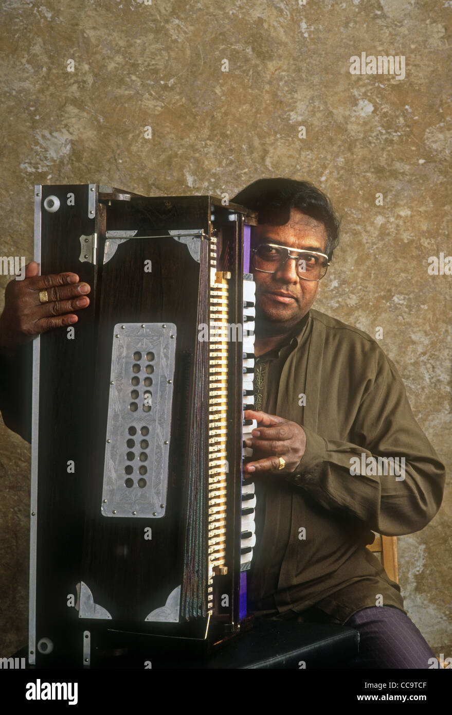 Hindu musician with a harmonium Stock Photo