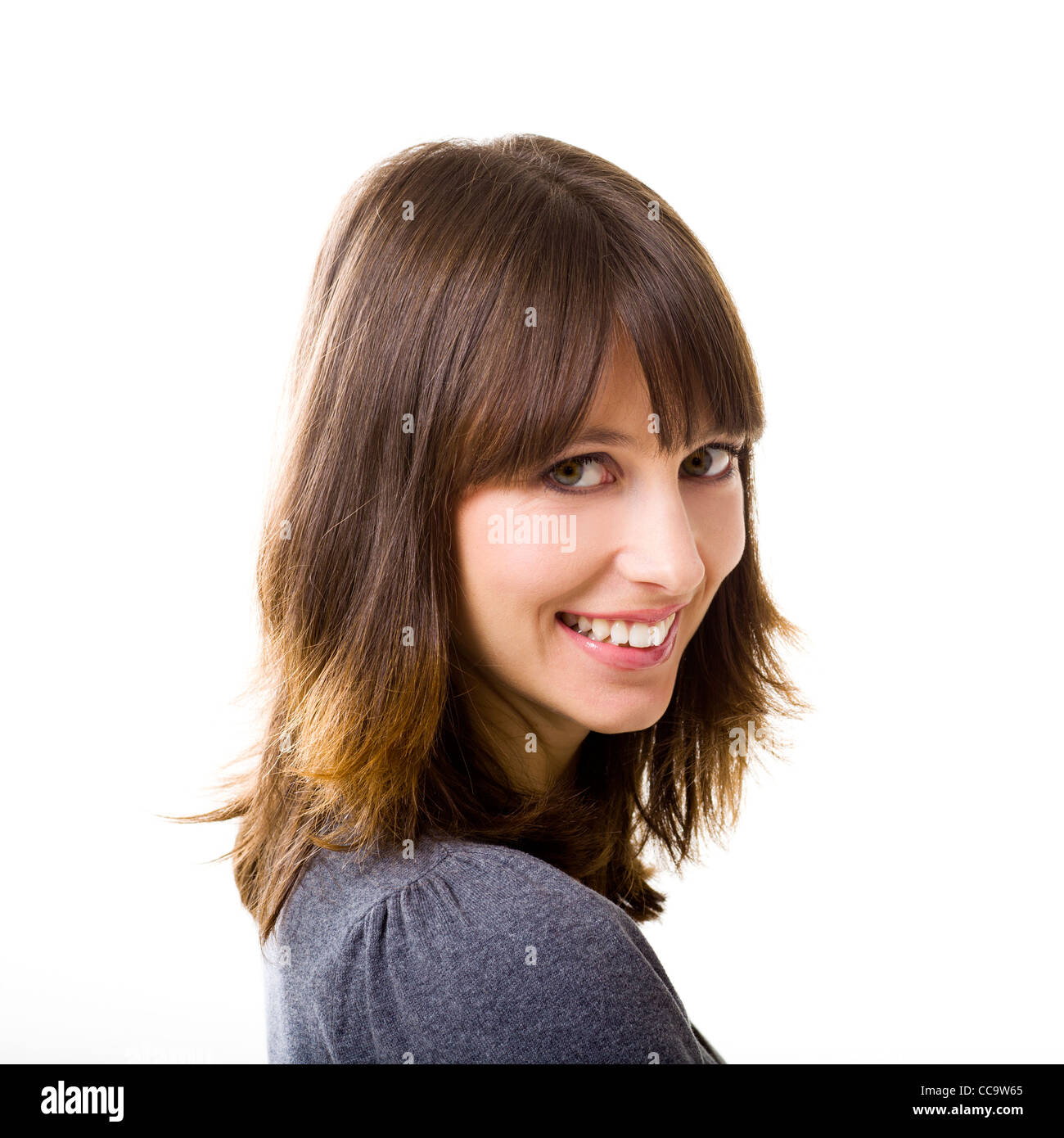 Portrait of a beautiful young woman looking at the camera and smiling ...