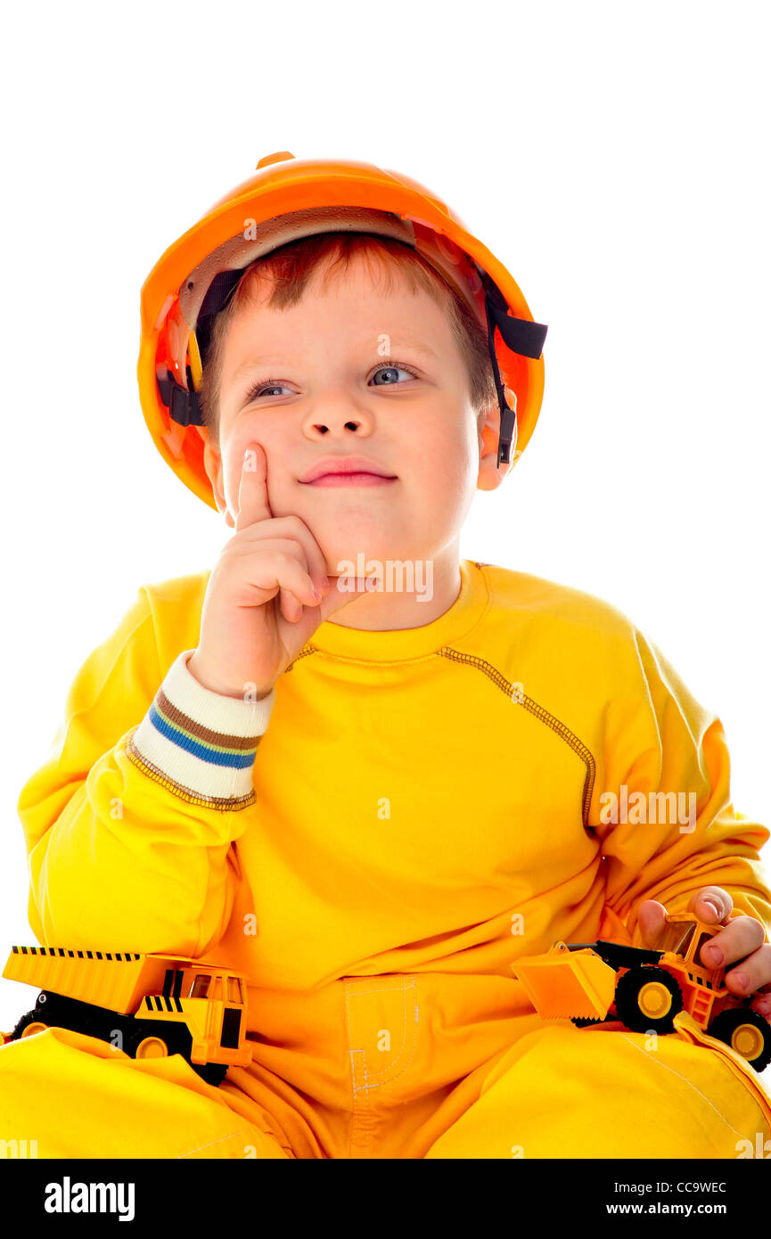 Little boy with helmet and tools. isolated on white. He is thinking