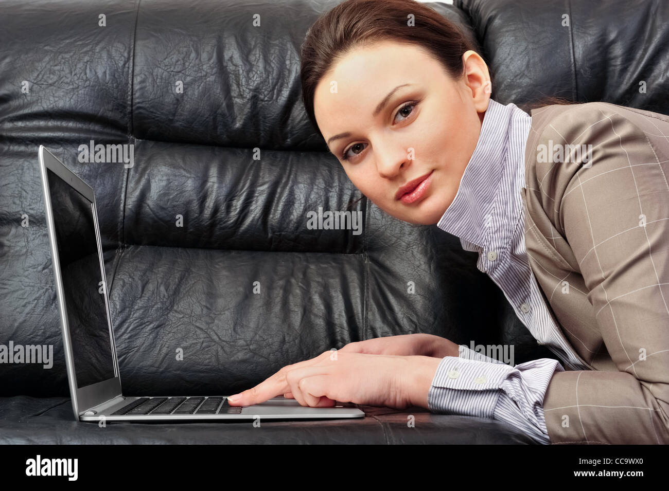 Portrait of a beautiful young woman working on laptop Stock Photo - Alamy