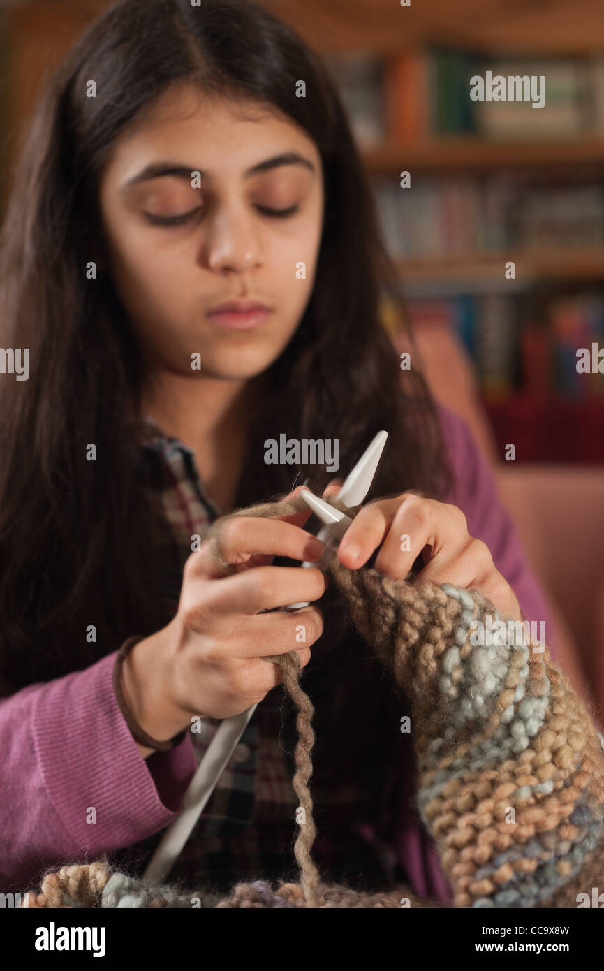 Teenager enjoying herself knitting, learning how to knit and learn new