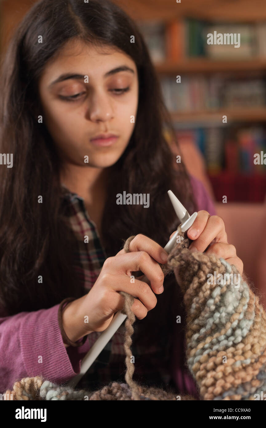 Teenager enjoying herself knitting, learning how to knit and learn new
