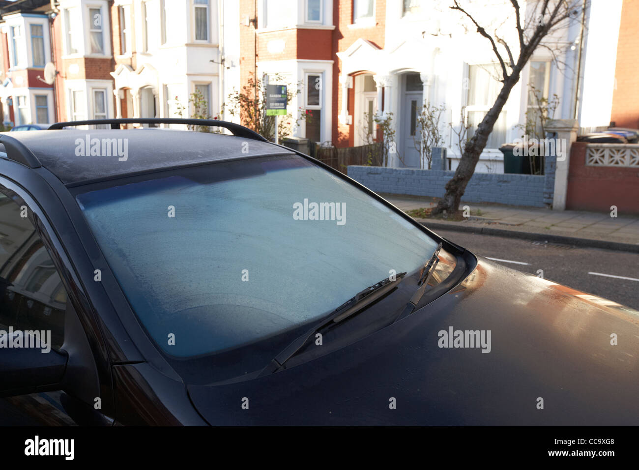 frost on a car window in a residential street early on a winter morning cricklewood north london england uk Stock Photo