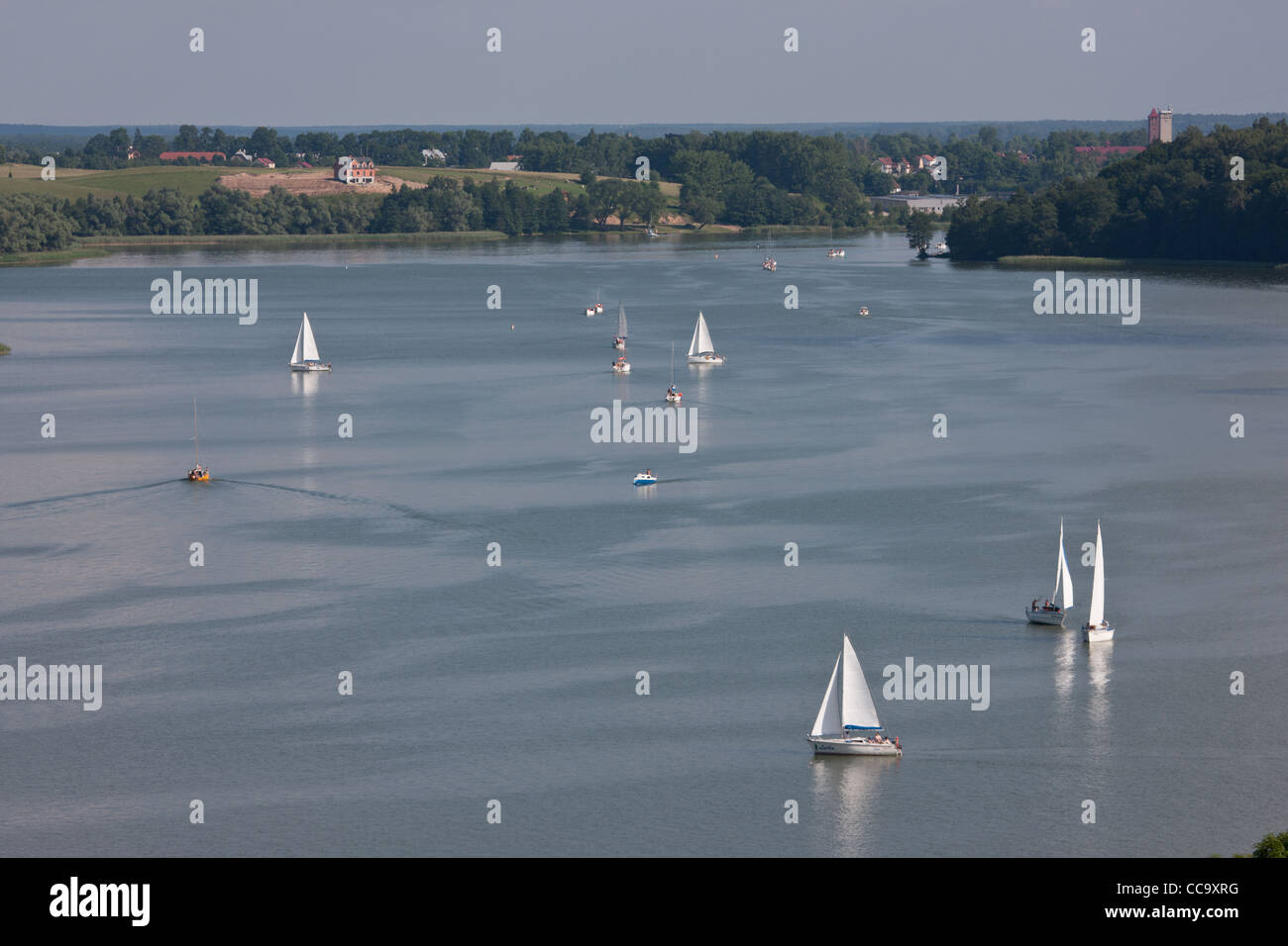 View from the flight of the lake, 'Talty' in Masuria. On the water sail boats and yachts, and in the distance town 'Mikolajki' Stock Photo