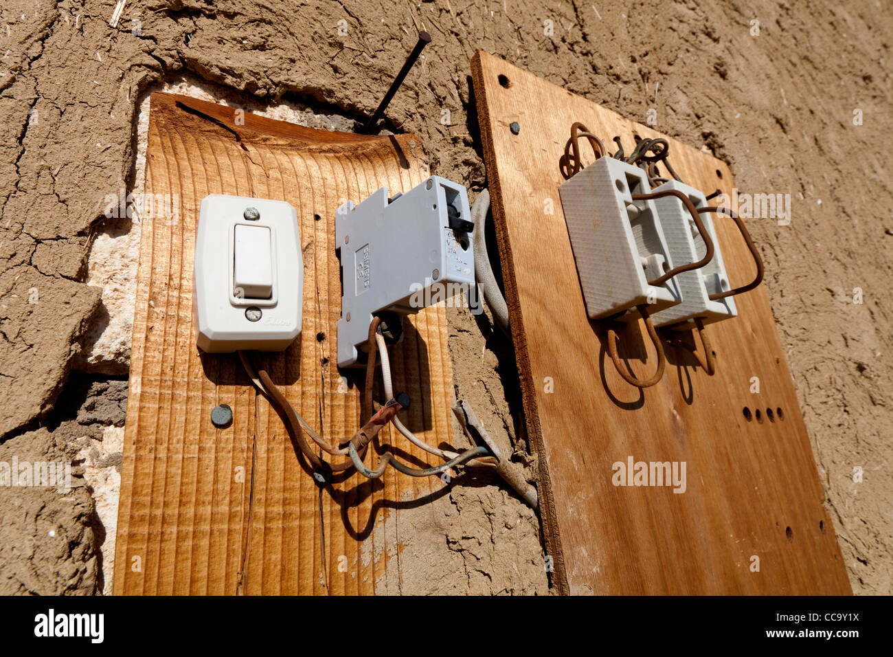 switches and wiring on side of a building out in the open air in Egypt Stock Photo