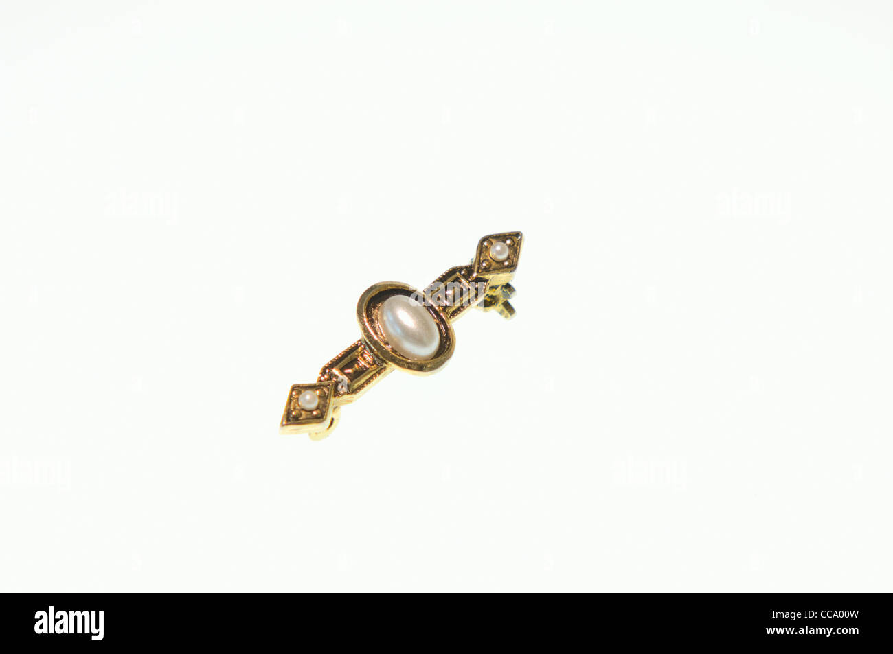 Gold pin decorated with pearls Stock Photo